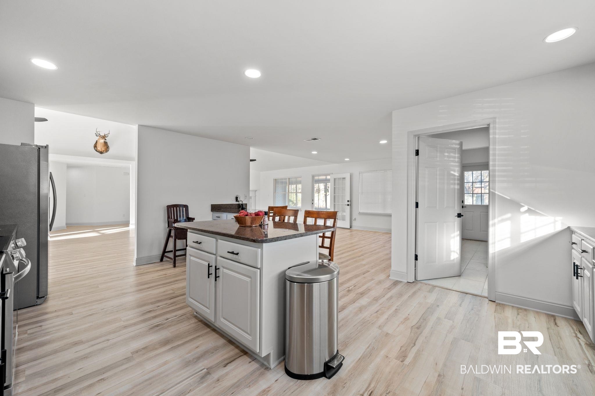 136 Destrehan Road Fairhope, AL 36532 - Photo 12 of 44 Kitchen featuring a center island, dark stone countertops, light hardwood / wood-style flooring, and stove
