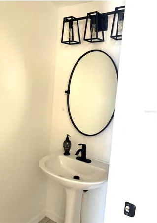 a bathroom with a sink and mirror