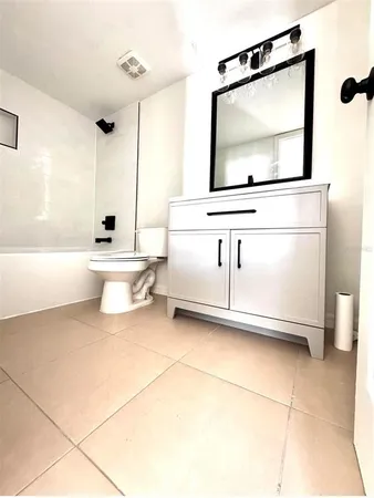 a bathroom with a sink a mirror and a bathtub