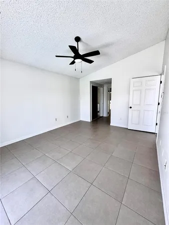 a view of an empty room with a ceiling fan