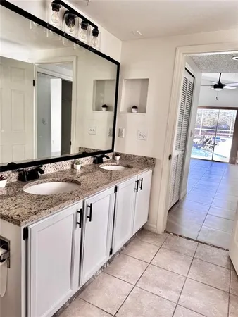 a bathroom with a granite countertop sink a mirror and a vanity