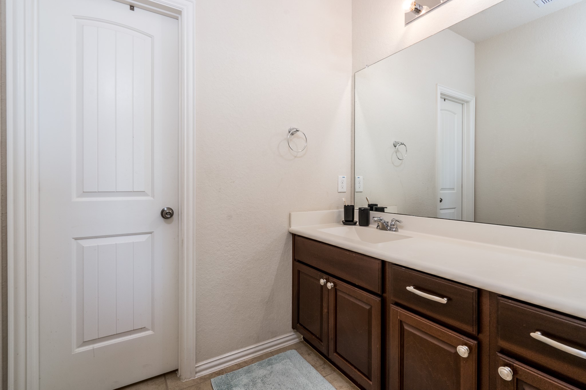 17823 Dappled Walk Way Cypress, TX 77429 - Photo 20 of 23 a bathroom with a sink a light fixture and a mirror