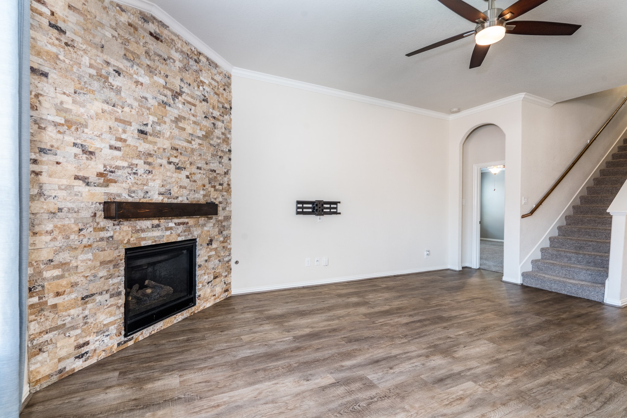 17823 Dappled Walk Way Cypress, TX 77429 - Photo 5 of 23 a view of a livingroom with wooden floor a fireplace and a ceiling fan