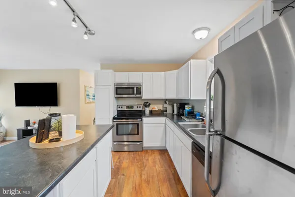 a kitchen with granite countertop lots of counter top space and living room