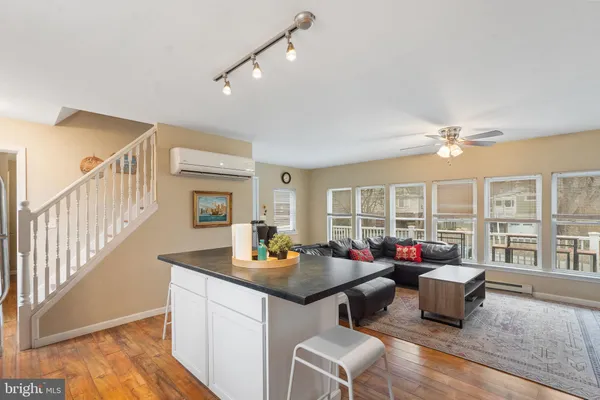 a living room with furniture and a floor to ceiling window