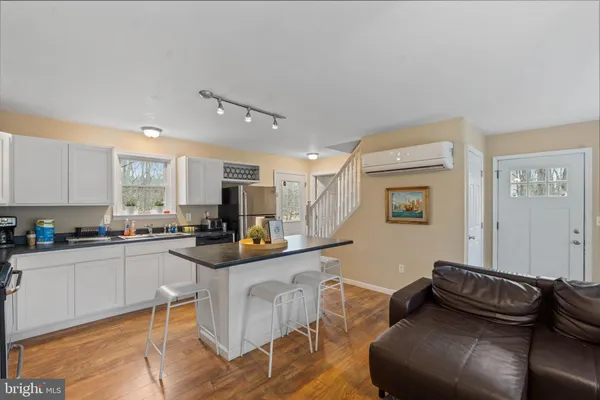 a kitchen with stainless steel appliances granite countertop a refrigerator sink and stove