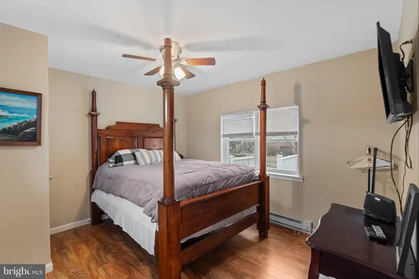 a living room with furniture large window and flat screen tv