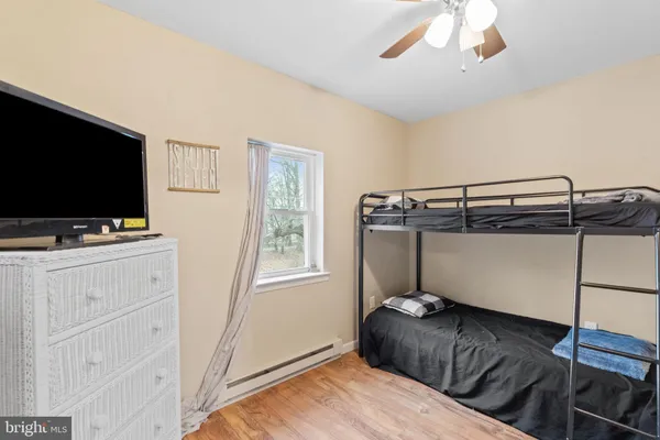 a living room with a flat screen tv and a floor to ceiling window
