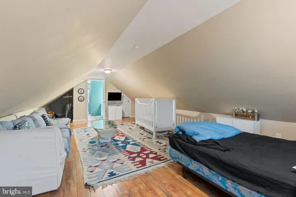 a living room with furniture and a baby crib