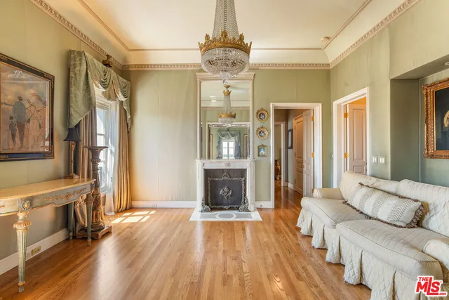 a bedroom with a bed and large windows