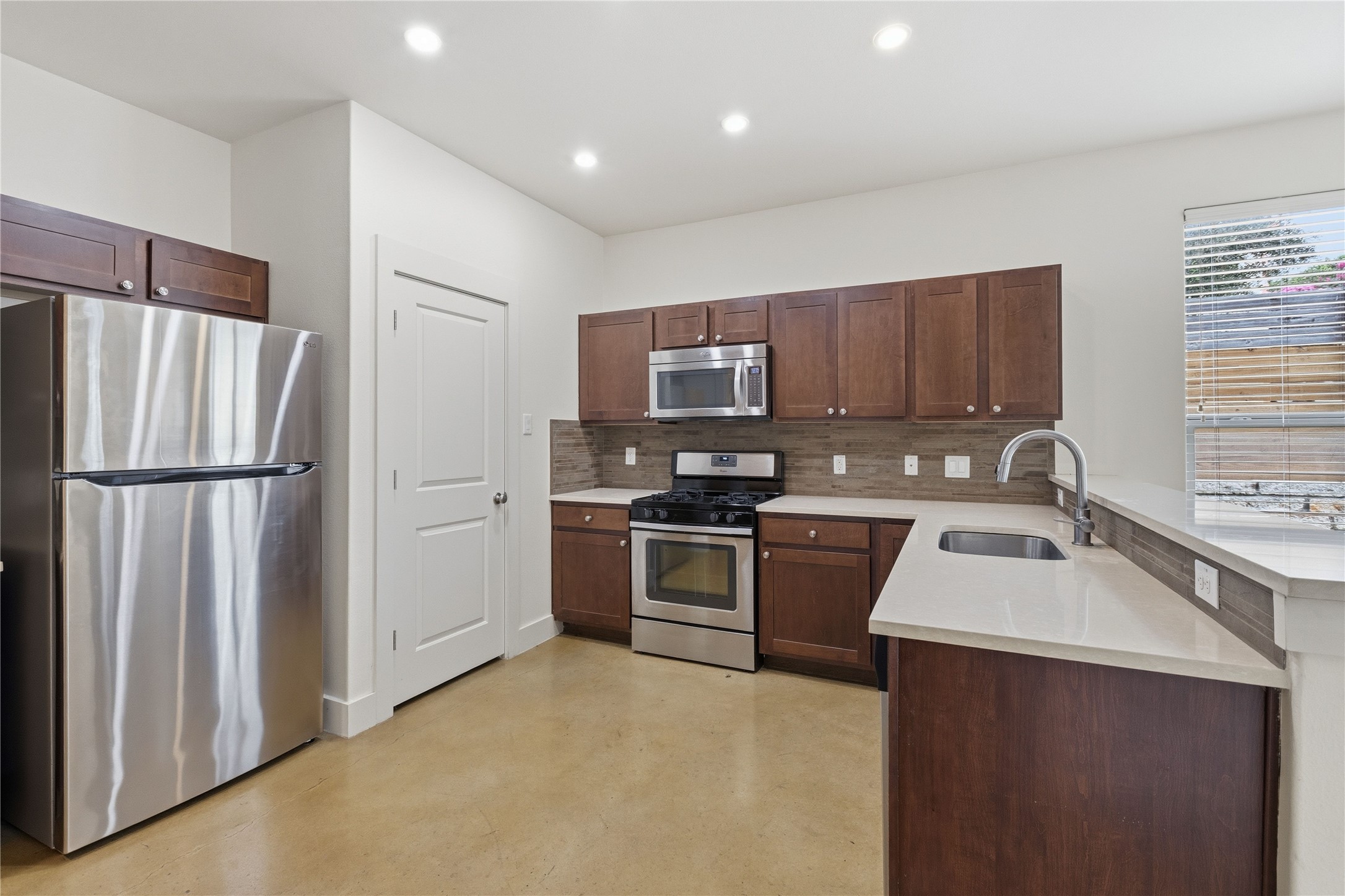 4124 Valley View Road, Unit 4A & 4B Austin, TX 78704 - Photo 8 of 40 A well-lit culinary space features stainless steel appliances and abundant cabinetry, ready for everyday meals or entertaining.