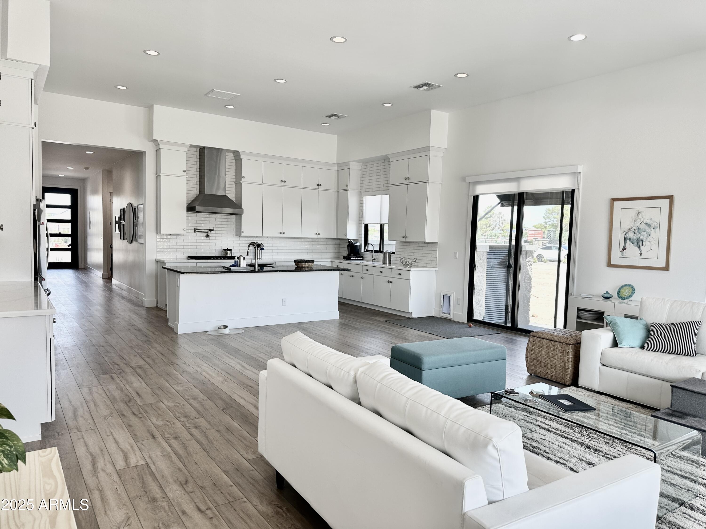 2725 East Derringer Court Gilbert, AZ 85297 - Photo 12 of 56 a living room with stainless steel appliances furniture and a wooden floor