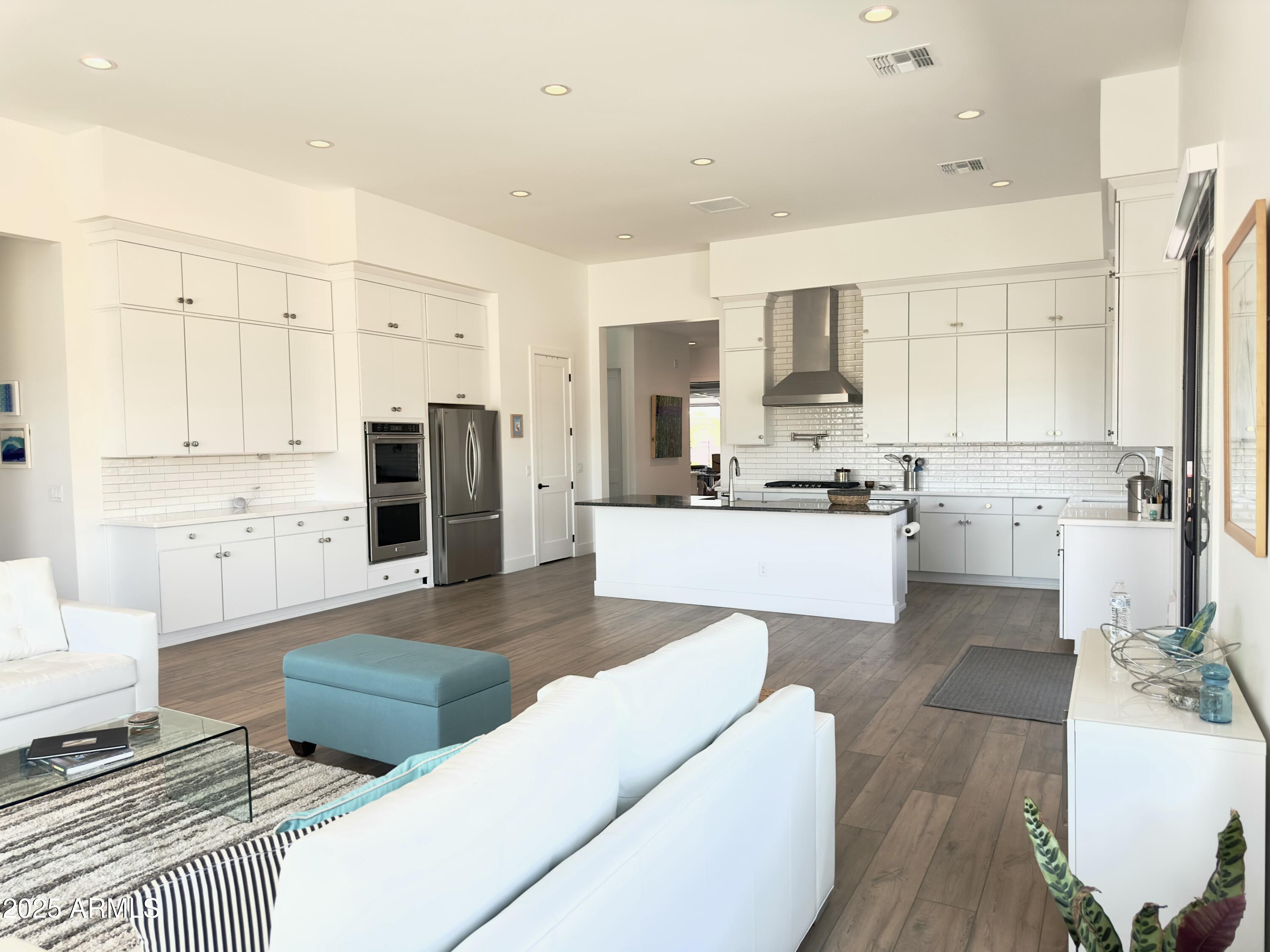 2725 East Derringer Court Gilbert, AZ 85297 - Photo 13 of 56 a living room with stainless steel appliances furniture a rug and a kitchen view