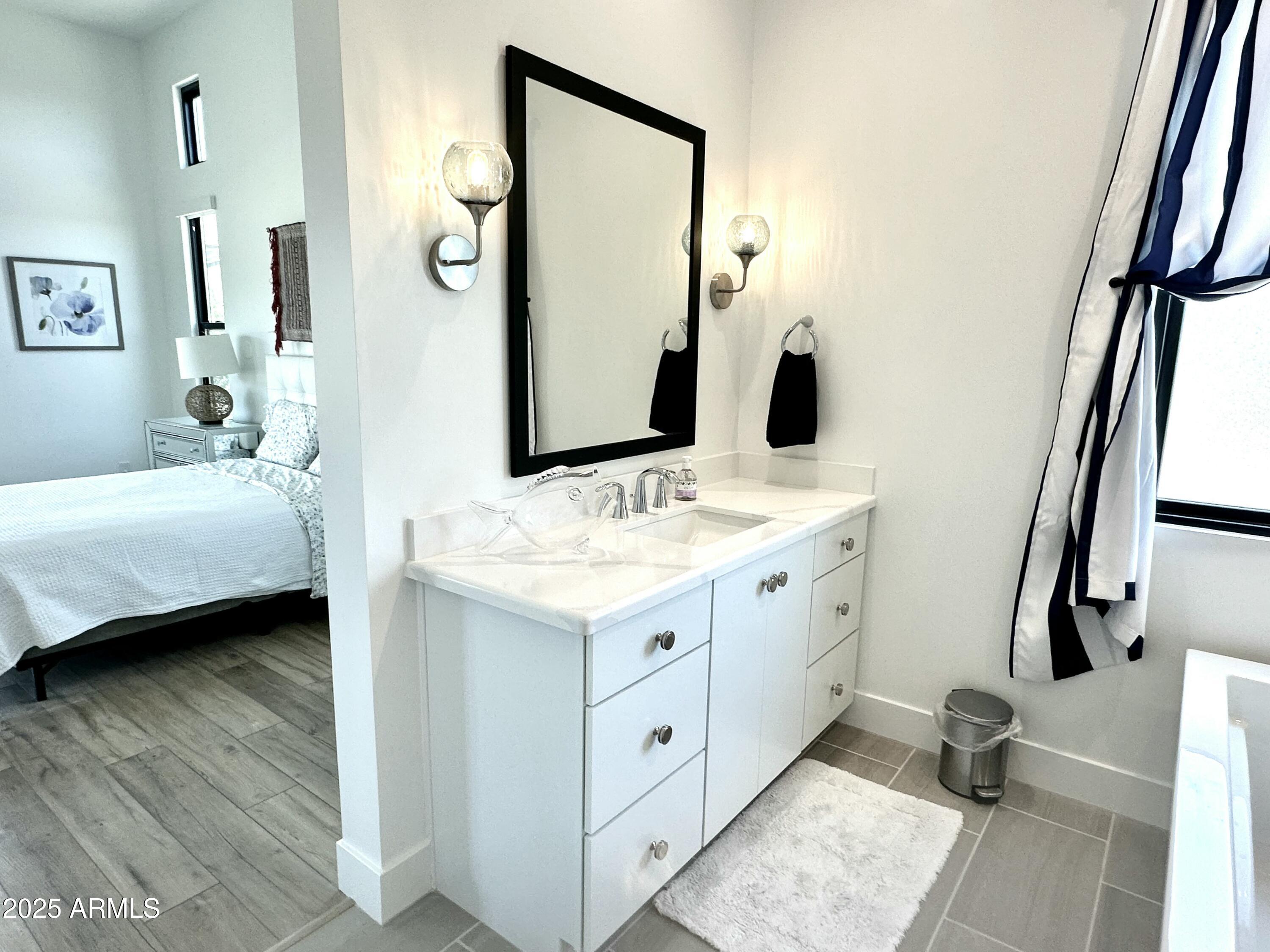 2725 East Derringer Court Gilbert, AZ 85297 - Photo 17 of 56 a spacious bathroom with a double vanity sink and a mirror