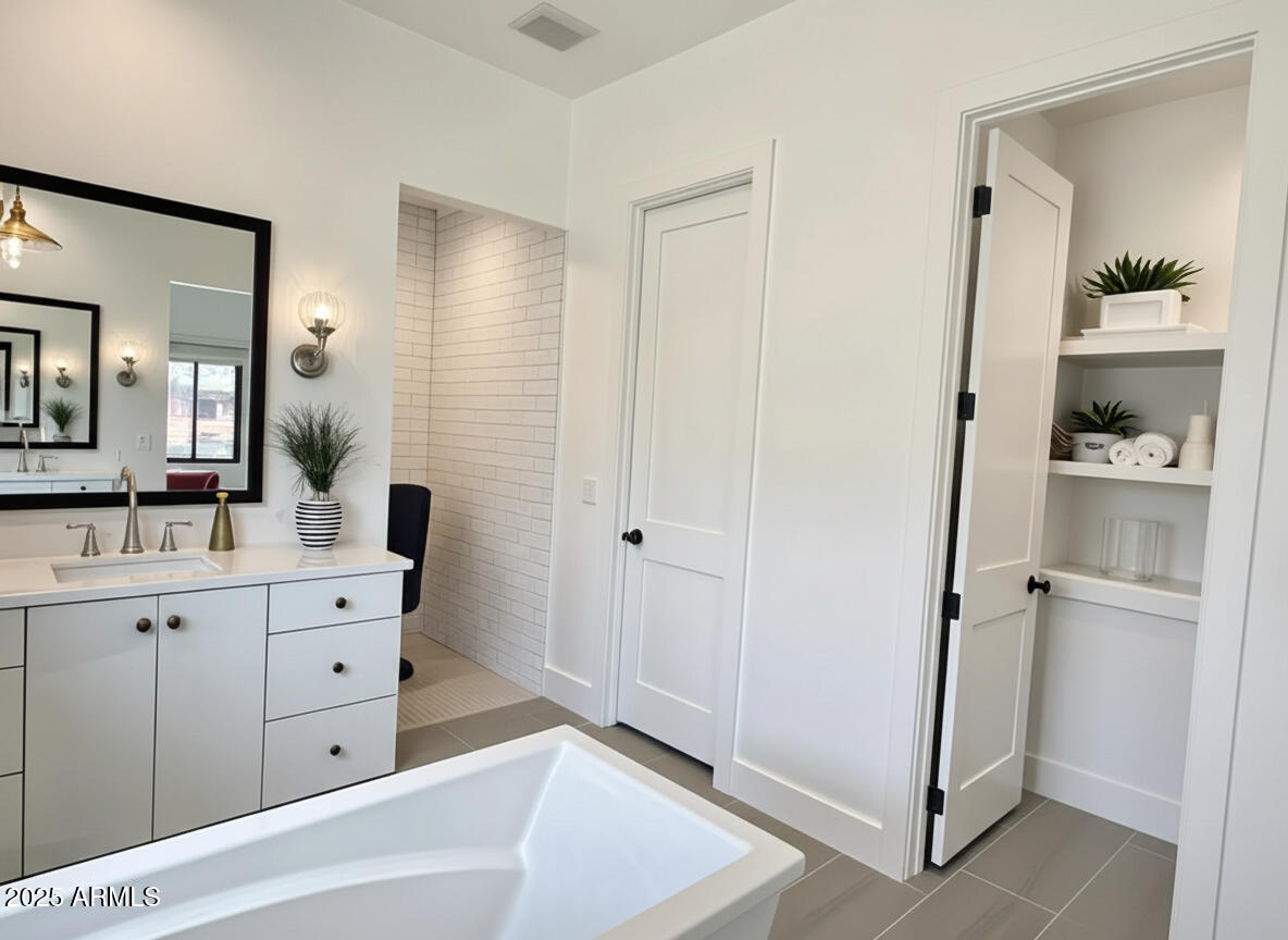 2725 East Derringer Court Gilbert, AZ 85297 - Photo 18 of 56 a spacious bathroom with a double vanity sink a mirror and a bathtub