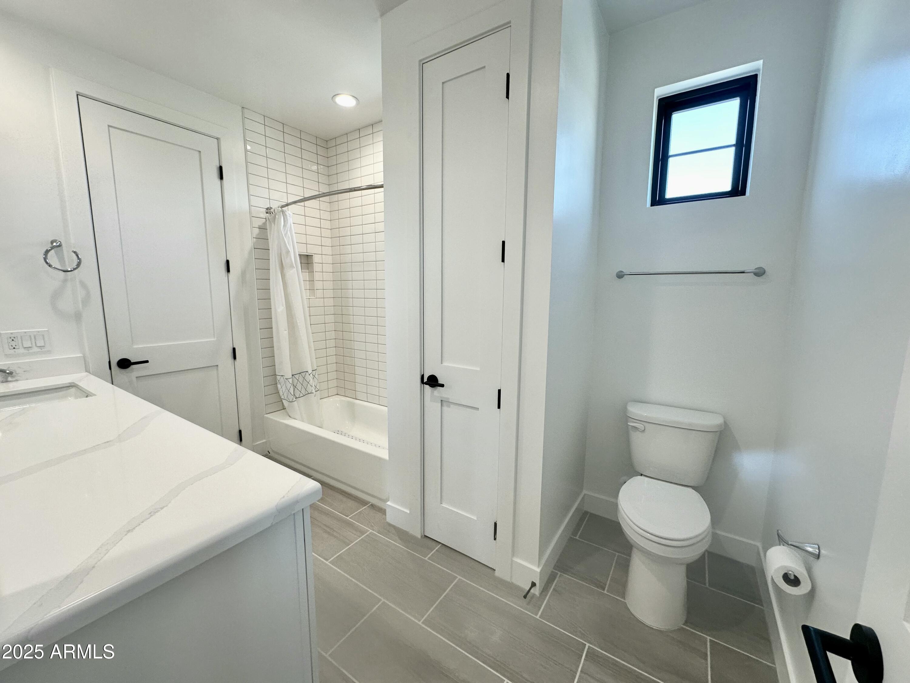 2725 East Derringer Court Gilbert, AZ 85297 - Photo 34 of 56 a bathroom with a granite countertop sink a toilet and shower