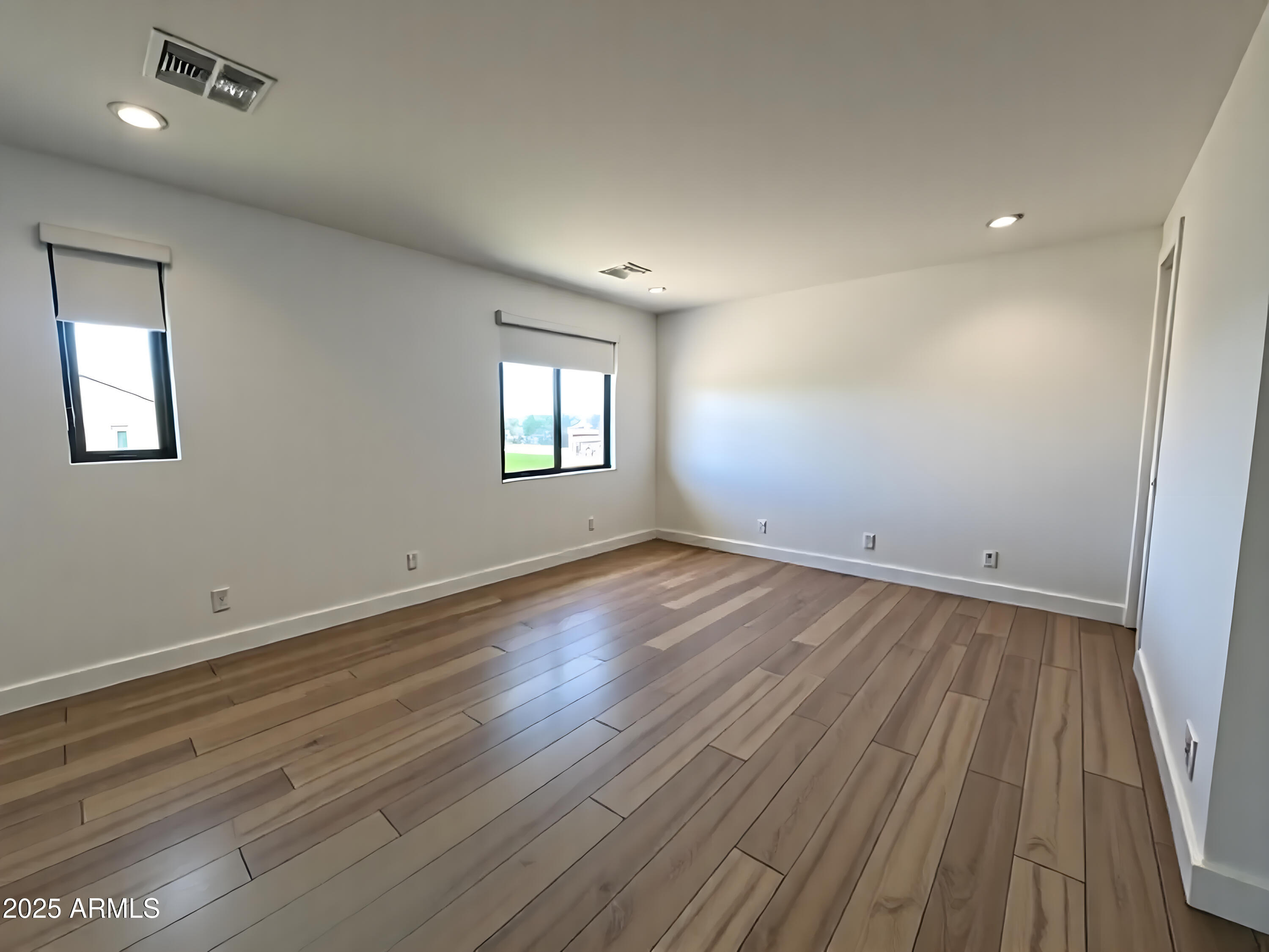 2725 East Derringer Court Gilbert, AZ 85297 - Photo 56 of 56 an empty room with wooden floor and windows