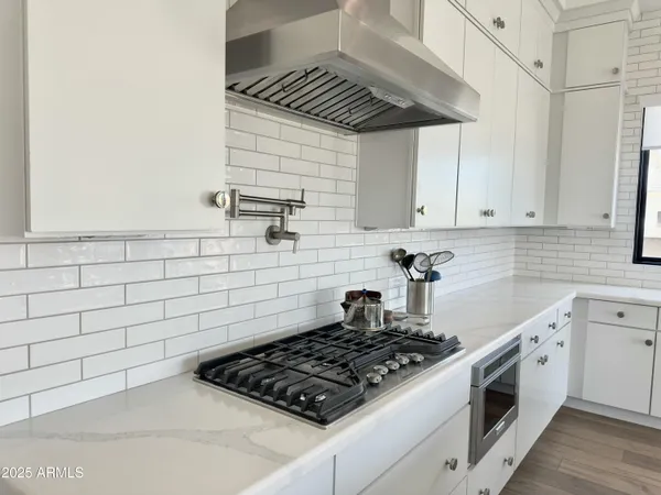 a kitchen with stainless steel appliances granite countertop a sink and cabinets