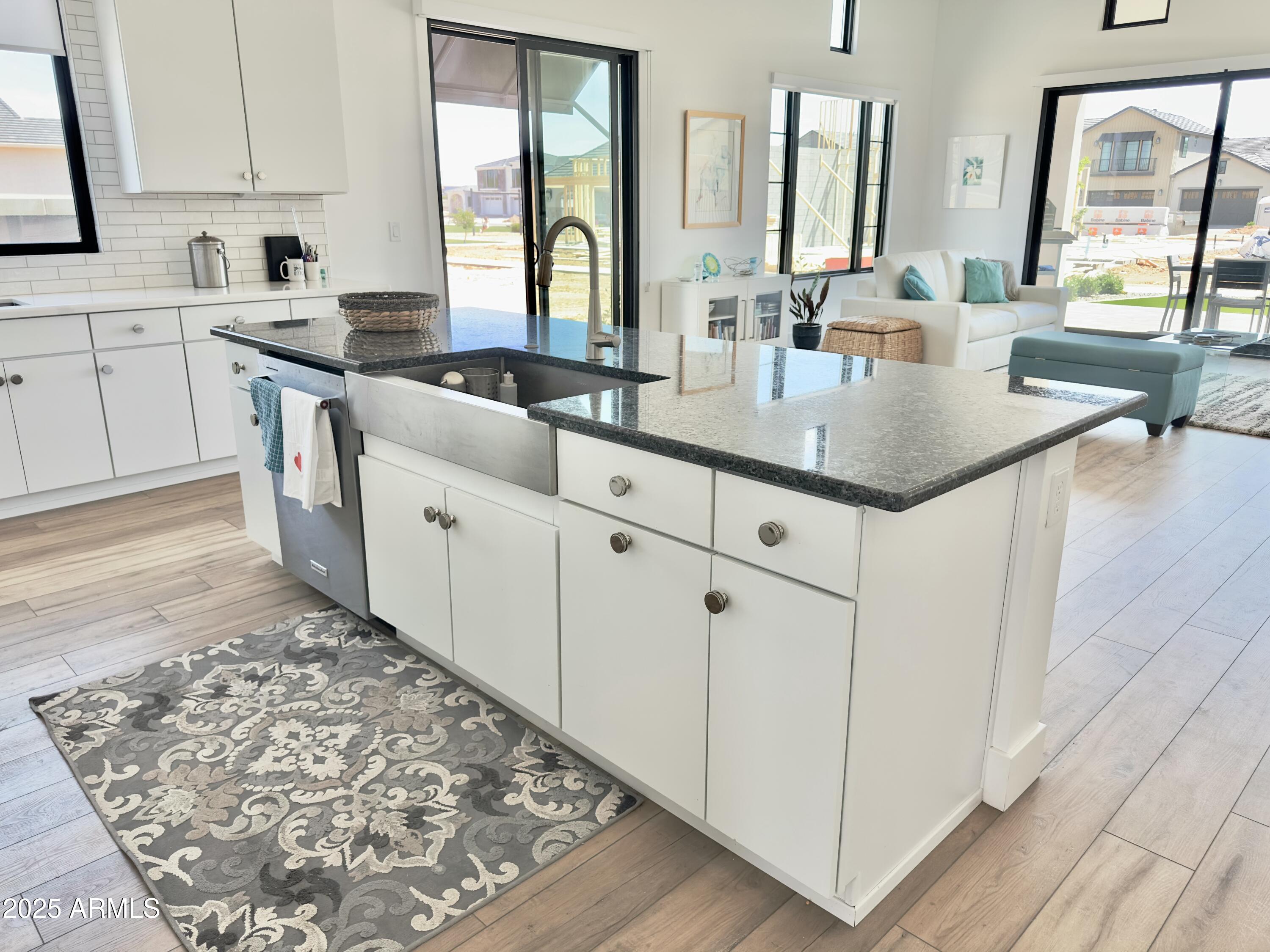 2725 East Derringer Court Gilbert, AZ 85297 - Photo 7 of 56 a kitchen with stainless steel appliances granite countertop a sink and cabinets