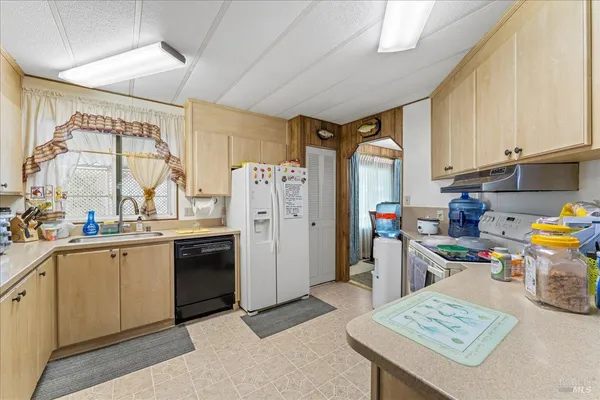 a kitchen with a refrigerator and a sink