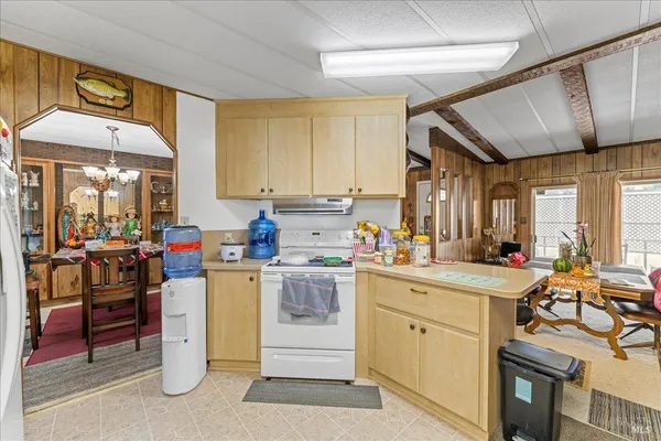 a kitchen that has a lot of cabinets in it and wooden floor