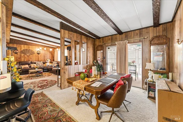 a living room with furniture and floor to ceiling windows