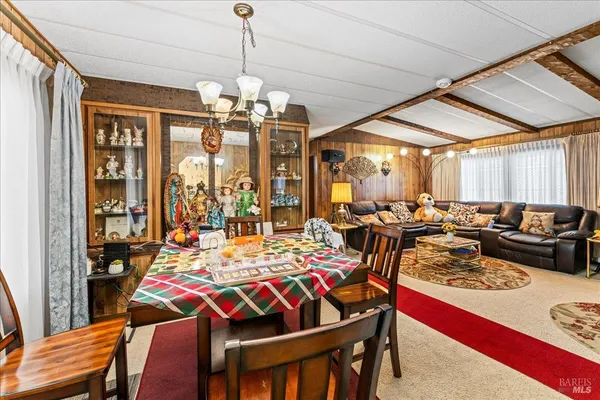 a view of a dining room with furniture and a chandelier