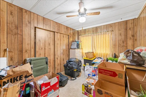 a bedroom with furniture and a large window