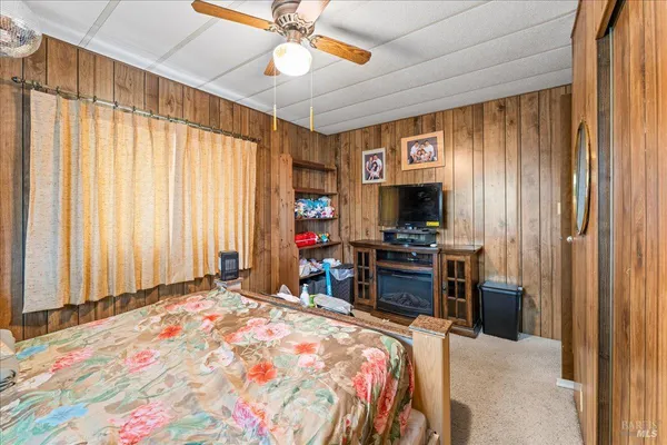 a bedroom with a bed and a television