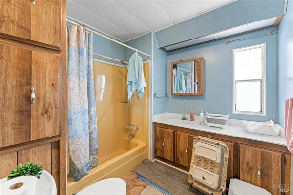 a bathroom with a sink a mirror and a shower