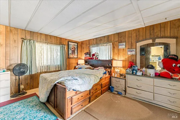 a bed room with a bed and a dresser
