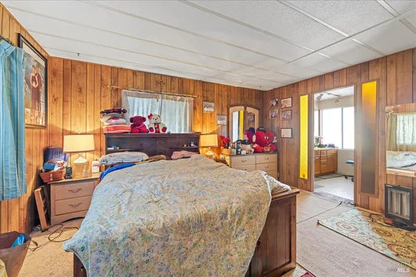 a bed room with a bed and a large window