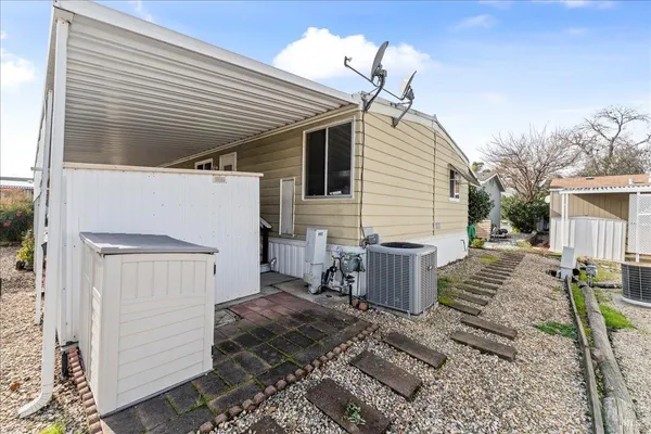 a view of a house with backyard and sitting area