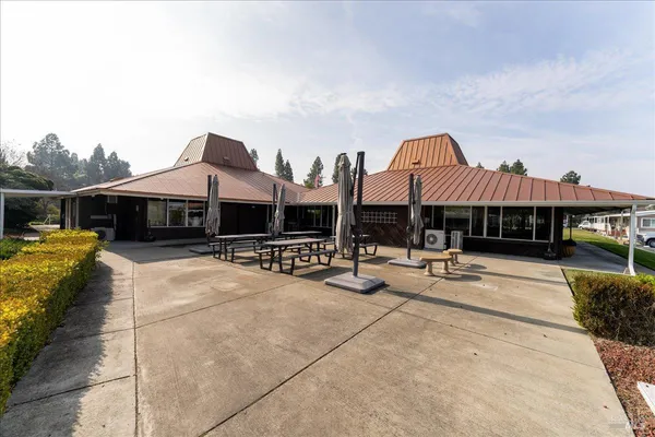 a view of a house with swimming pool and sitting area