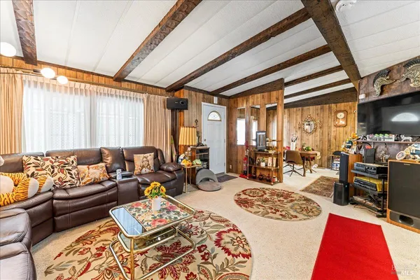 a bed room with a bed a couch and a window