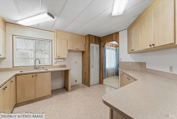 a kitchen with a sink stove and cabinets