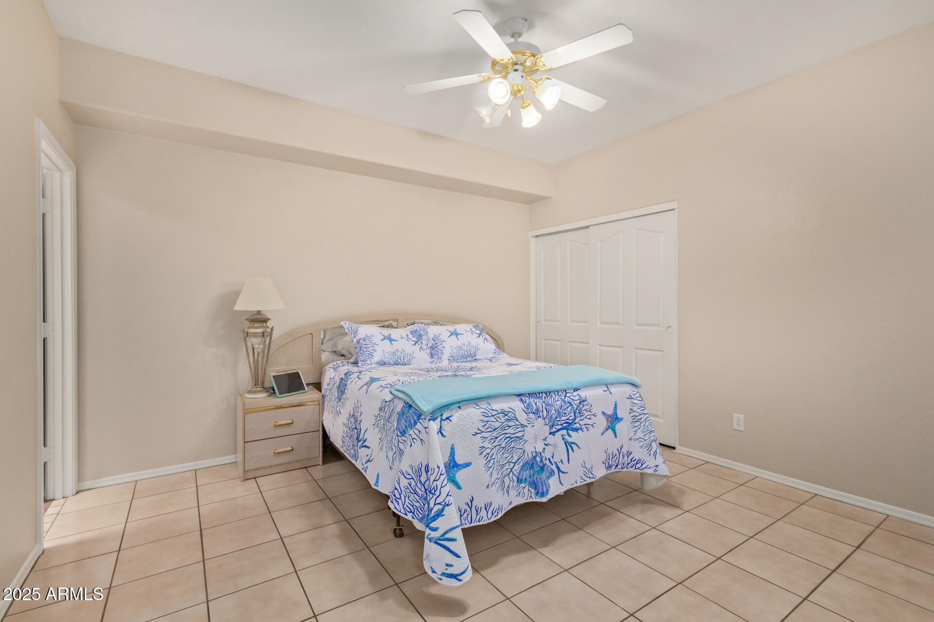 6001 East Southern Avenue, Unit 4 Mesa, AZ 85206 - Photo 21 of 23 a bed sitting in a bedroom next to a window and a chandelier