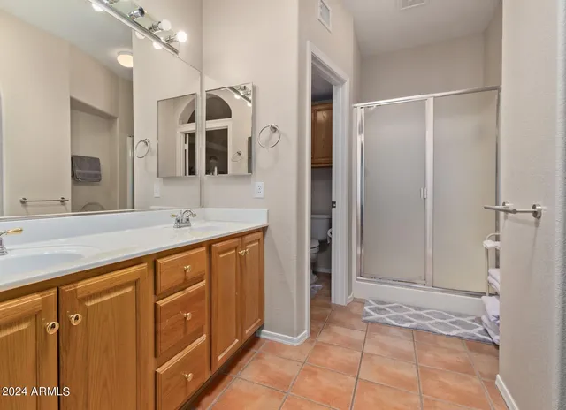 a spacious bathroom with a sink and a mirror