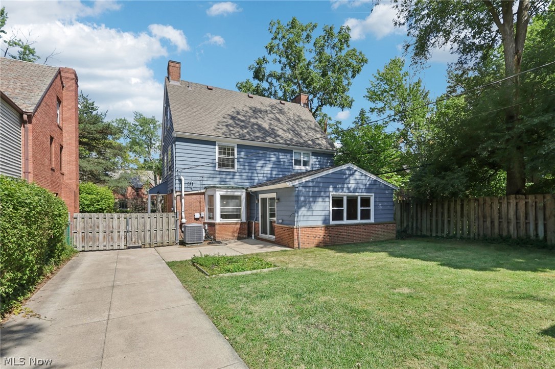 2620 Charney Road Cleveland, OH 44118 - Photo 43 of 43 Rear view of house featuring central AC unit and a yard