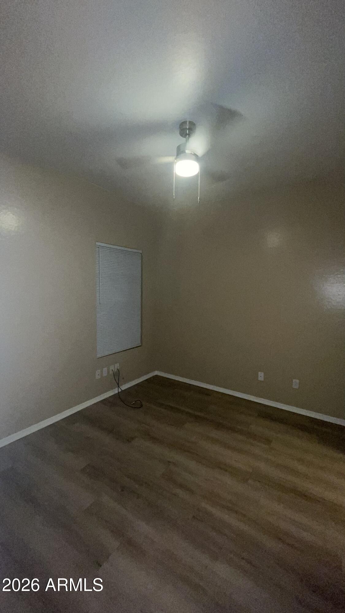 10640 West Coronado Road Avondale, AZ 85392 - Photo 15 of 26 a view of an empty room and wooden floor