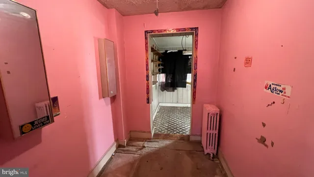 a view of storage and utility room with wooden walls