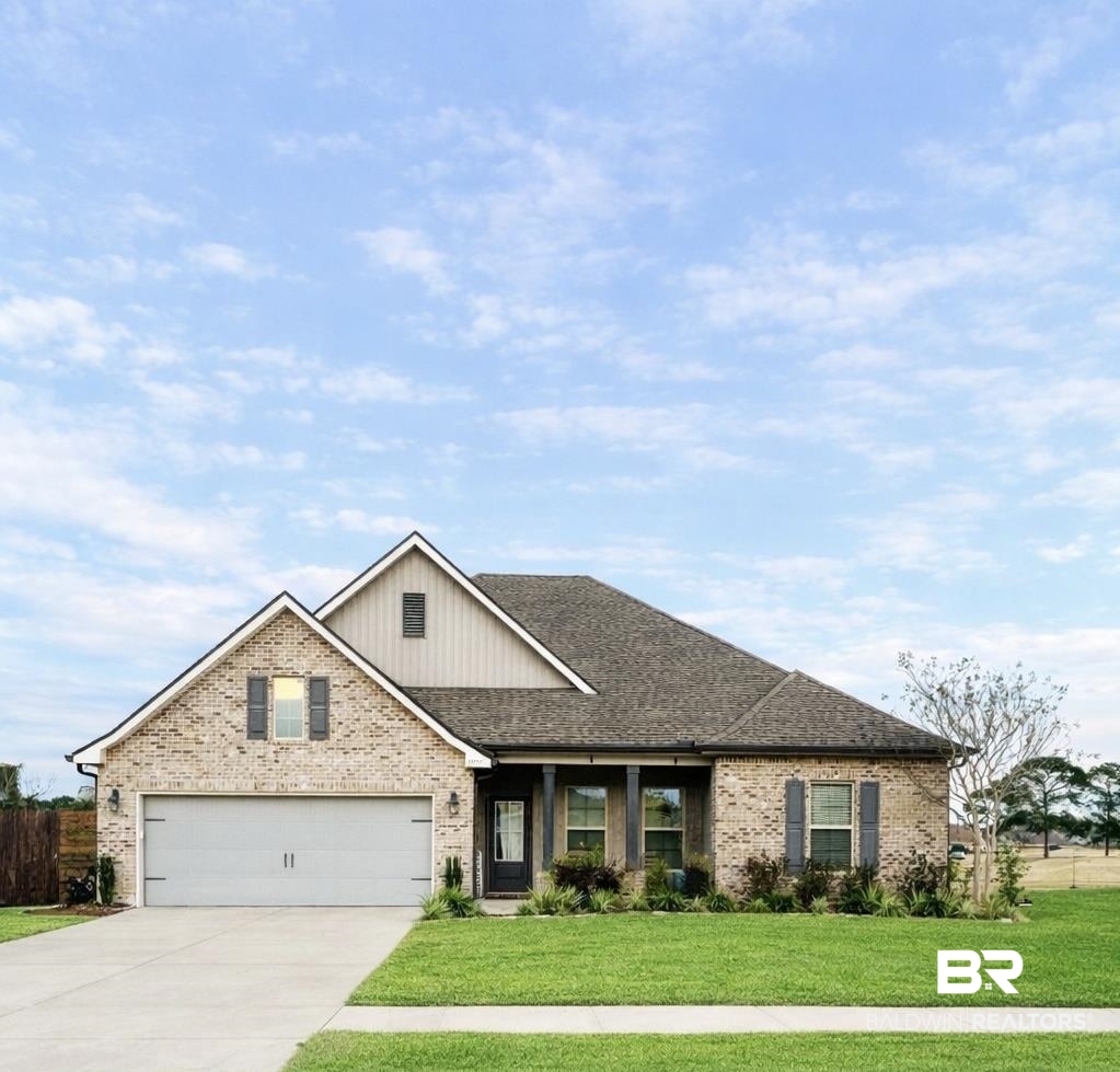 22531 Putter Lane Foley, AL 36535 - Photo 1 of 43 View of front facade with brick siding, driveway, roof with shingles, a porch, and board and batten siding