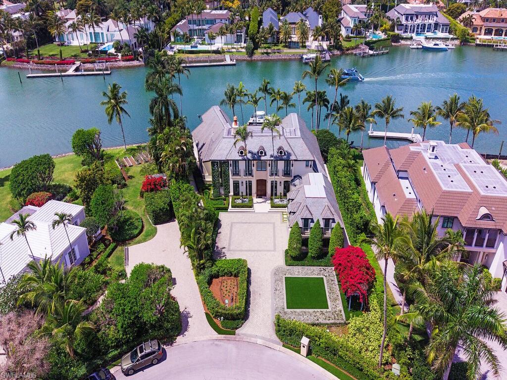 3580 Gin Lane Naples, FL 34102 - Photo 1 of 38 an aerial view of a house with a lake view