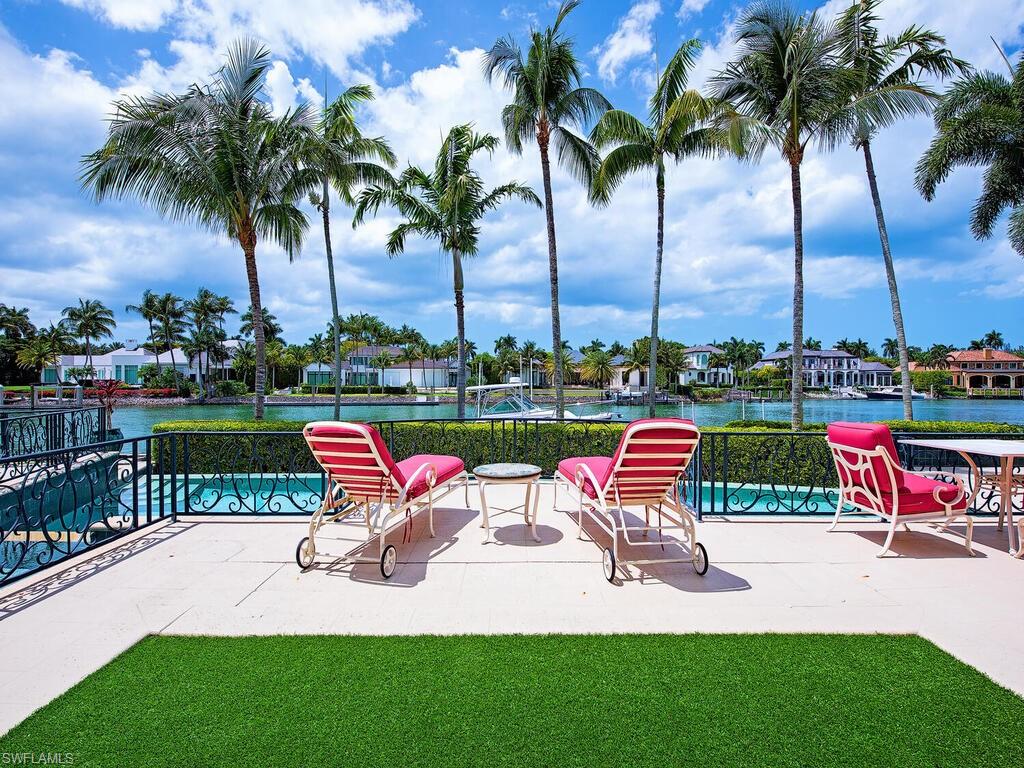 3580 Gin Lane Naples, FL 34102 - Photo 13 of 38 a view of outdoor space with seating area and lake view