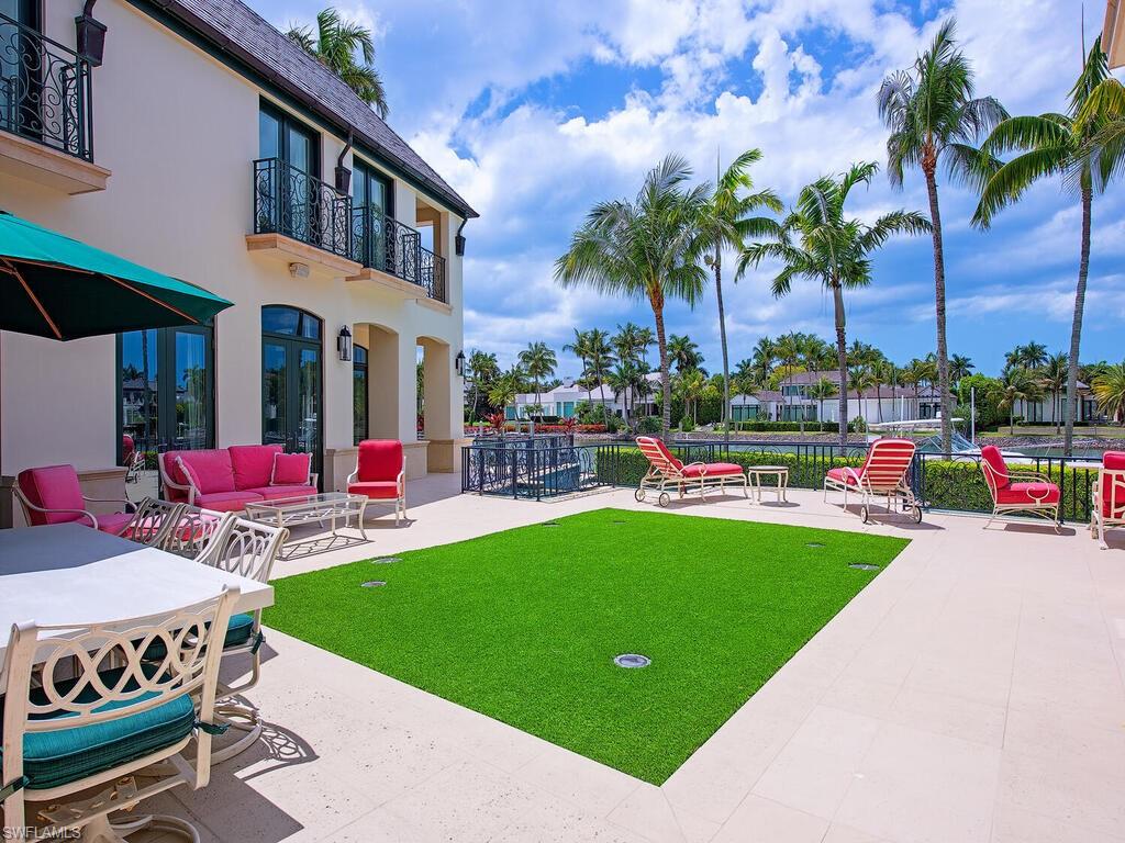 3580 Gin Lane Naples, FL 34102 - Photo 14 of 38 a front view of a house with swimming pool garden and patio