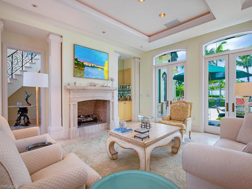 3580 Gin Lane Naples, FL 34102 - Photo 15 of 38 a living room with furniture and a fireplace