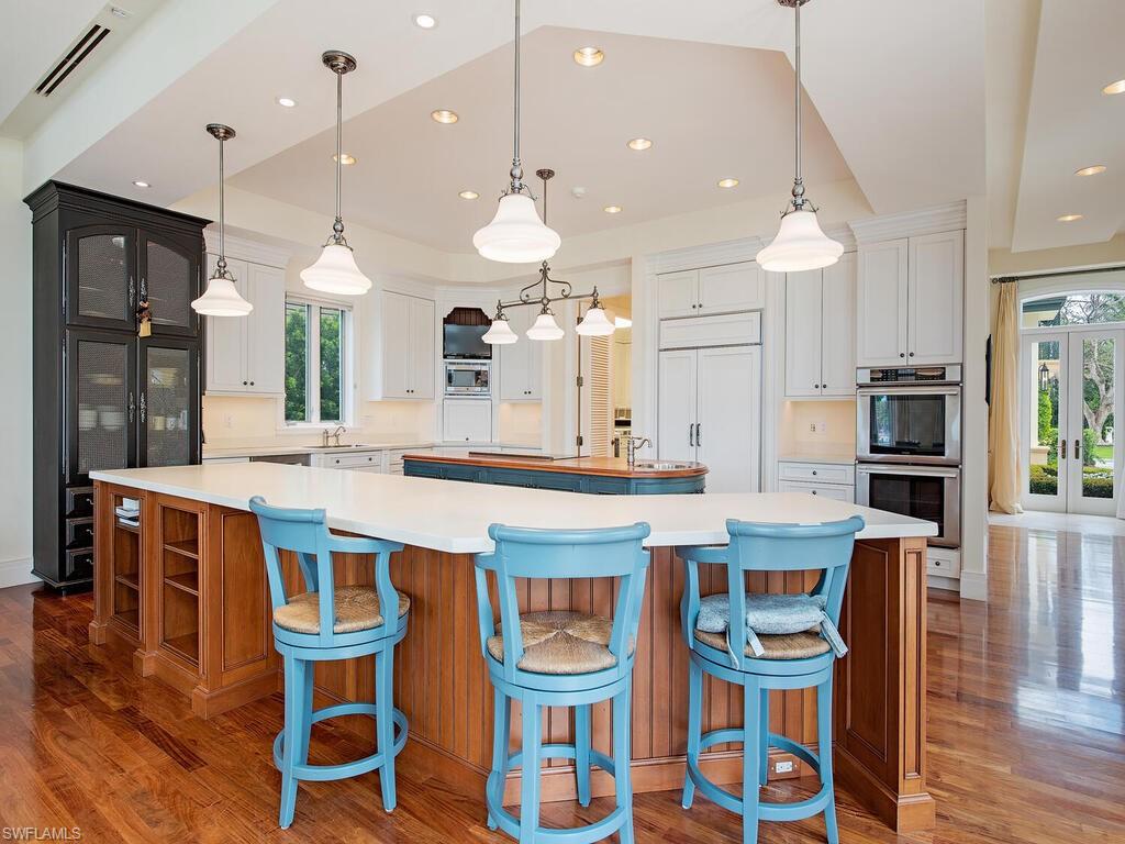 3580 Gin Lane Naples, FL 34102 - Photo 18 of 38 a large kitchen with a table and chairs