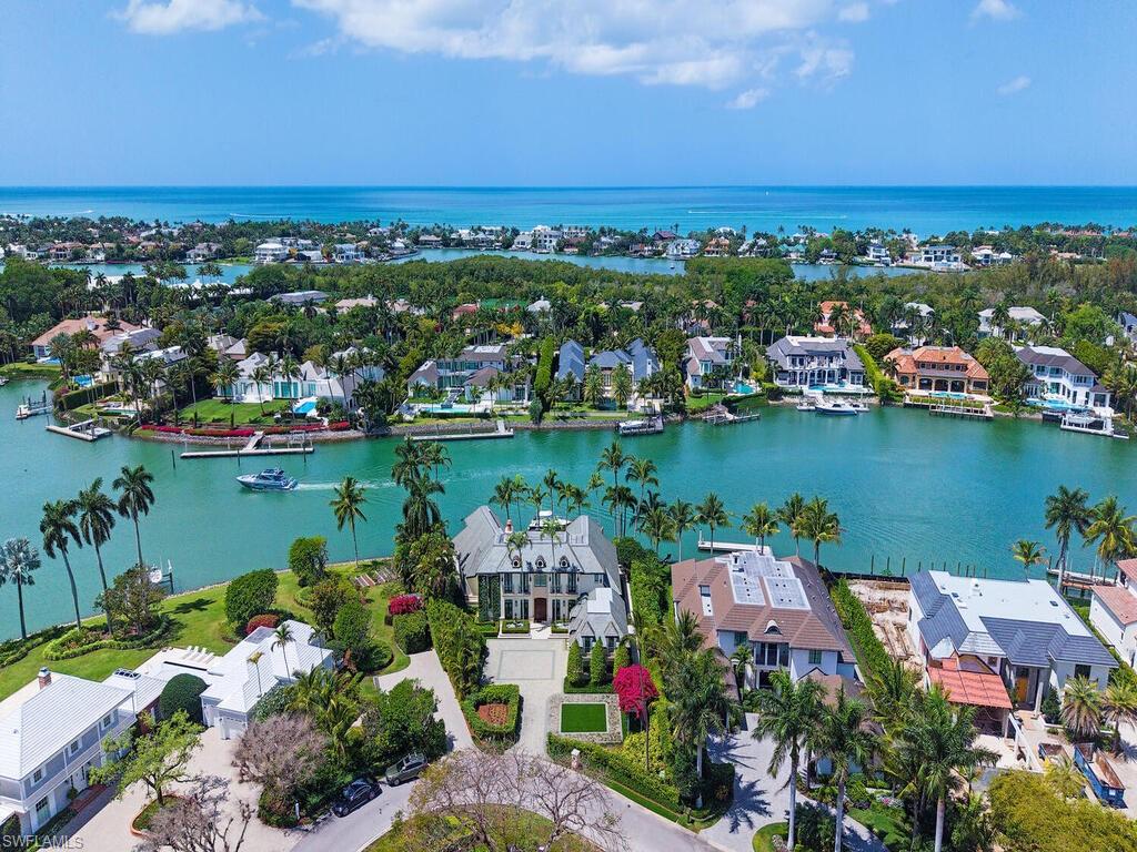 3580 Gin Lane Naples, FL 34102 - Photo 2 of 38 an aerial view of a house with a lake view
