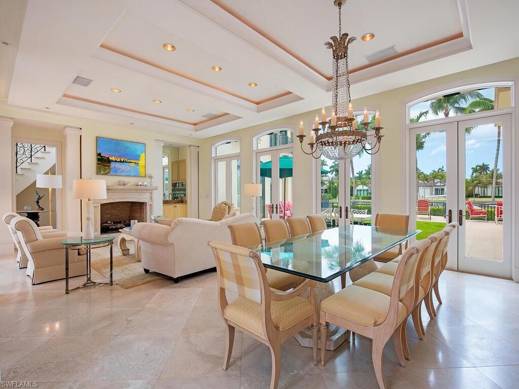 3580 Gin Lane Naples, FL 34102 - Photo 21 of 38 a view of a dining room with furniture wooden floor and chandelier