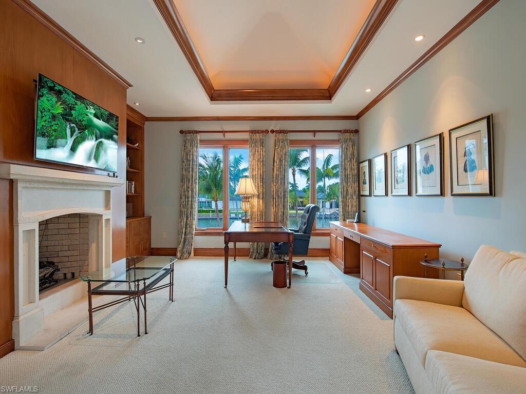 3580 Gin Lane Naples, FL 34102 - Photo 27 of 38 a living room with furniture and a fireplace